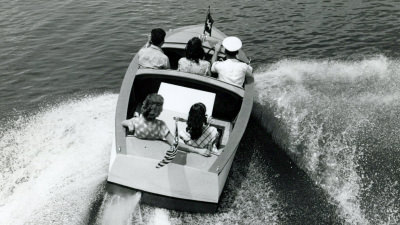 Guests Cruising in boat on lake