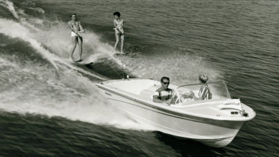 Water skiers being pulled by Correct Craft boat