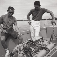 Men on board analyzing boat